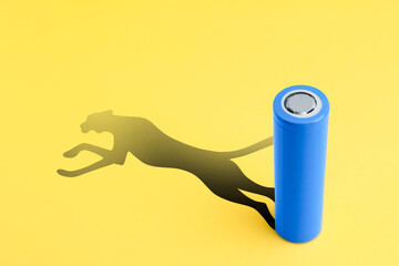 Alkaline battery with shadow in shape of jaguar on yellow background