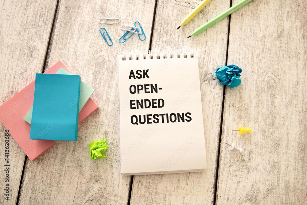 Poster ask open-ended questions written on a notebook page, pencil on the left.