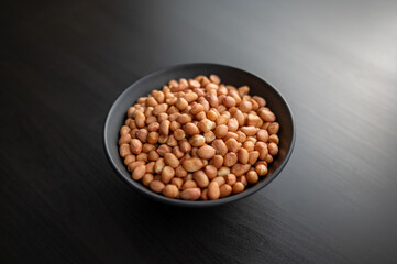 Healthy Snacking. A bowl of raw peanuts symbolizes a nutritious and protein-rich snack option.