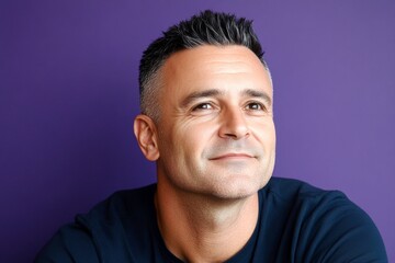 Obraz premium Concept art of style for aging men. A man with timeless beauty and confidence. Purple solid background. Elegant men's classic short back and sides haircut - midlife white man with black hair.