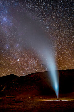 Bolivia. Geyser erupting in Bolivia's Sol de Manana with Milky Way behind.