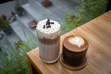 Tiramisu frappe and Coffee latte on cafe table. Beverages. Cold and summer drink.