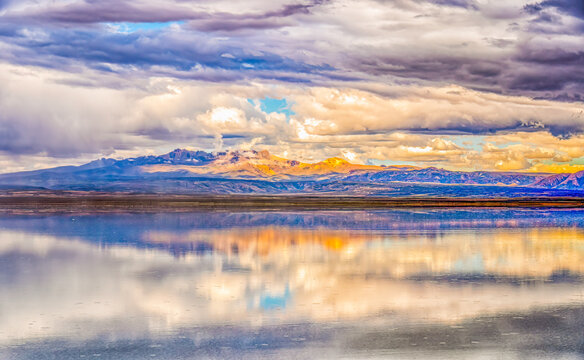 Salar de Uyuni, Bolivia. Storm clouds reflected over the Salar de Uyuni, with the Andes Mountains