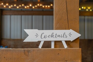 wedding cocktails sign in a barn © Heidi