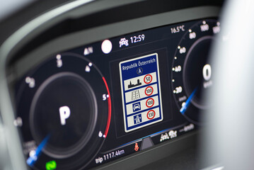 Information about speed limits in Austria is shown on the display in the cockpit of a modern car