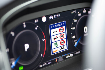 Information about speed limits in Denmark is shown on the display in the cockpit of a modern car