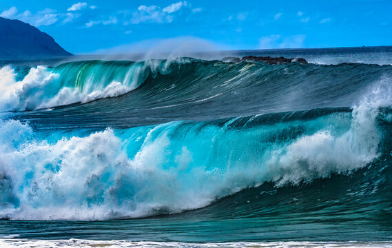Watching large waves Waimea Bay, North Shore, Oahu, Hawaii. Bay is famous for big wave surfing.