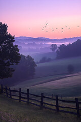 Golden Morning Glow: Serenity and Tranquility at First Light of Dawn Spreading Across the Landscape