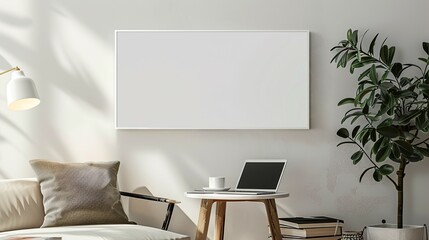 A white rectangular frame mounted above a small table in a living room with a laptop, a cup, and a pile of books. HD 8K wallpaper mockup Photographic Image