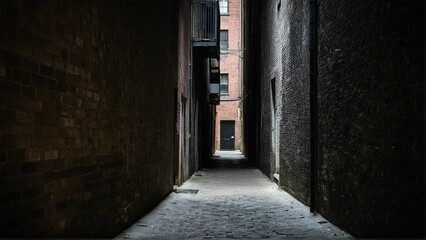 Descending into the Depths: A Long, Dark Alleyway Lined with Brick Walls and a Distant Glimmer of Hope.