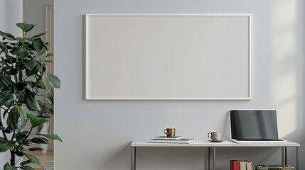 A white rectangular frame mounted in a hallway, above a small table with a cup, a laptop, and some books. HD 8K wallpaper mockup Photographic Image