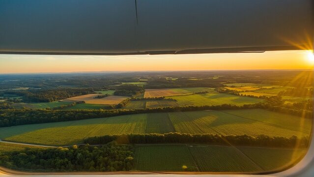 Aerial Vista: Fields of Gold Illuminated by the Setting Sun as Seen Through the Airplane Window's Frame.
