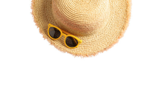 Bright straw hat sits alongside yellow sunglasses for sun protection, isolated on white, PNG