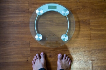 Person Standing on Modern Bathroom Scale to Check Body Weight