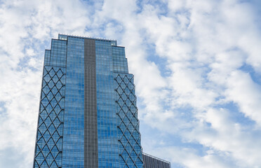 Modern Glass Skyscraper Reaching Into Cloudy Sky Urban Architecture Design