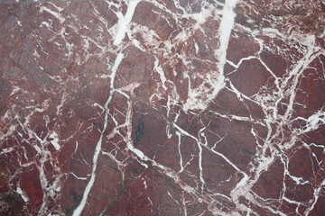 Natural red stone with white veins in detailed texture view