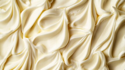 Obraz premium an artistic close-up displaying the smooth and elegant texture of a light buttercream frosting forming elegant patterns with a subtle gradient of white and soft cream hues