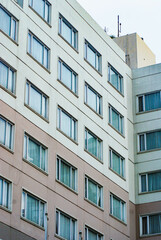 Hotel building full of glass and multi-storey floors, high-rise hotel building, Yogyakarta tourist area, soft hotel colors