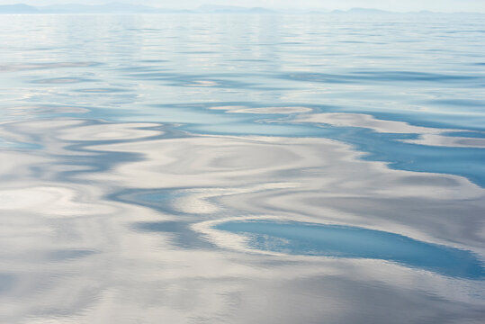 USA, Strait of Georgia. Cloud patterns reflection on calm Salish Sea.