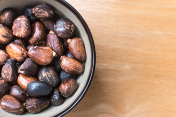 Authentic photo of cooked breadnut seeds (Maya nut) served in a rustic bowl on a wooden surface.