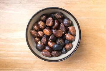 Authentic photo of cooked breadnut seeds (Maya nut) served in a rustic bowl on a wooden surface.
