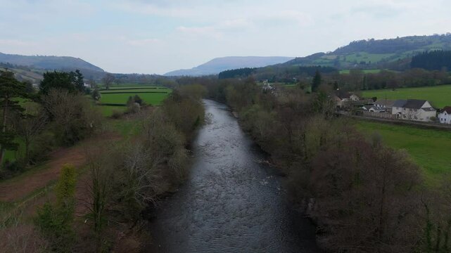 River Usk near Crickhowell Wales with fields hills and rural houses shown in 4K drone video view