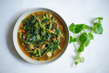 A plate of stir fry Pepperomia pellucida herb 