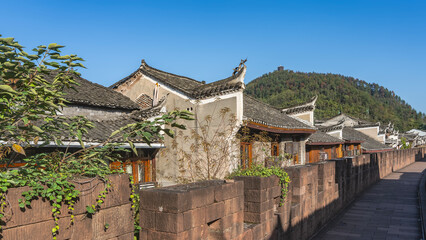 The fortress wall of Fenghuang Ancient Town. Old stone brickwork, walking path. Behind the fence...
