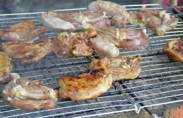fried pork and chicken on the grill