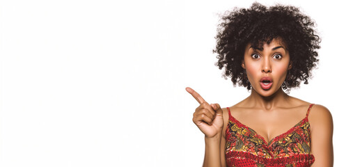 Shocked young woman pointing up with open mouth on white background