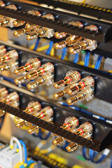 Connectors for connecting speakers to audio amplifiers in a telecommunications rack. 