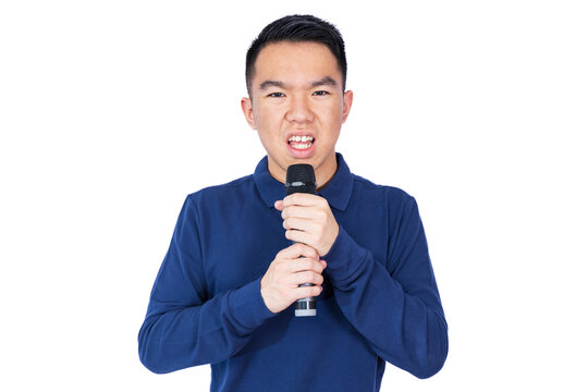 A young man in a blue polo shirt grips a microphone tightly with both hands, his expression tense and nervous. This image conveys fear, anxiety, or discomfort with public speaking or stage fright. - Powered by Adobe