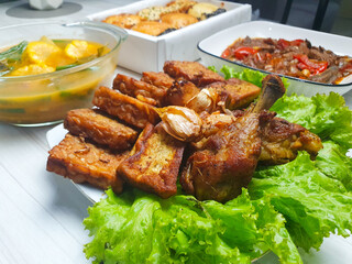 Fried chicken and tempe on the dining table. A type of Indonesian family food.