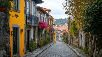 Picturesque cobbled street with vibrant facades and lush vegetation in Portugal
