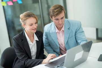 Professional colleagues collaborate at a modern office workspace during a productive meeting in the afternoon