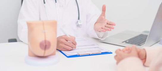 woman Patient consultation with doctor for Breast Augmentation Surgery, October Breast Cancer...