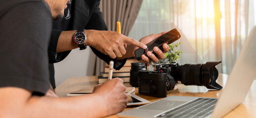 Man checking pictures on camera at home. Photographer reviewing his work.