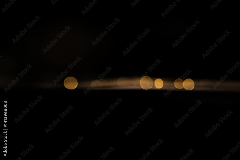 Leinwandbilder Flickering blurred gold bokeh lights illuminate the darkened background at night, Flickering blurred gold colored ed dots bokeh on clean black copy space background