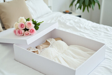 bouquet of flowers and a pair of shoes in a white box