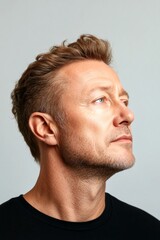 Fototapeta premium Pure white solid background. Chic men's crew cut haircut - midlife white man with blond hair. A cheerful and poised gentleman standing elegantly. Concept graphic drawing of style for aging me.