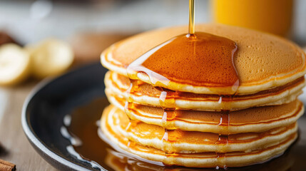 stack of pancakes with syrup cascading down, creating delicious and inviting breakfast scene