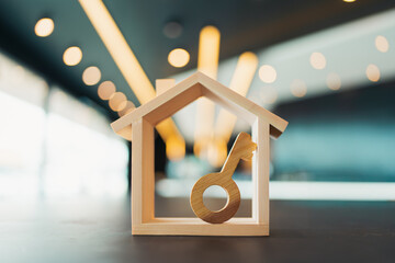 House model and hole key on wood table. Real estate agent offer house, property insurance and...