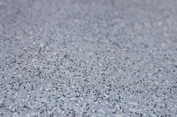 Full frame macro abstract texture background of sparkling silvery white glitter surface with copy space
