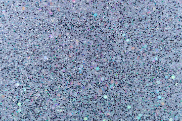 Full frame macro abstract texture background of sparkling lavender and black glitter surface with copy space