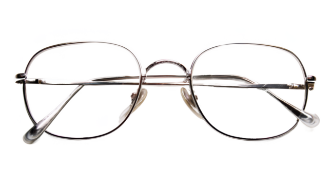 Vintage Vision: A Pair of Classic Wire-Rimmed Glasses Offering a Glimpse into the Past, Framed Against a Timeless Black Backdrop.