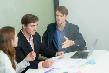 Business meeting in a modern office with team discussing project details and strategies in the afternoon