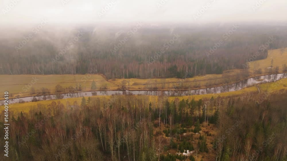 Poster aerial view of a winding river through autumn fields and forests under an overcast sky, with visible
