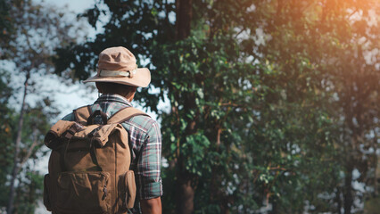 Obraz premium Travel and backpack concept. A young man is hiking with a backpack in the forest. Close up legs of young asian hiking man standing, Adventure hikes, Enjoy holidays