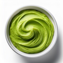 Obraz premium Smooth wasabi paste in white ceramic bowl, isolated on white background