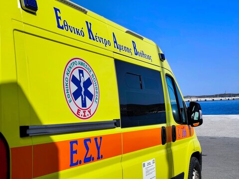 Closeup view of a Greek National first aid center (EKAV or EKAB) ambulance stationed at the Port of Syros, symbolizing emergency medical readiness on the island.